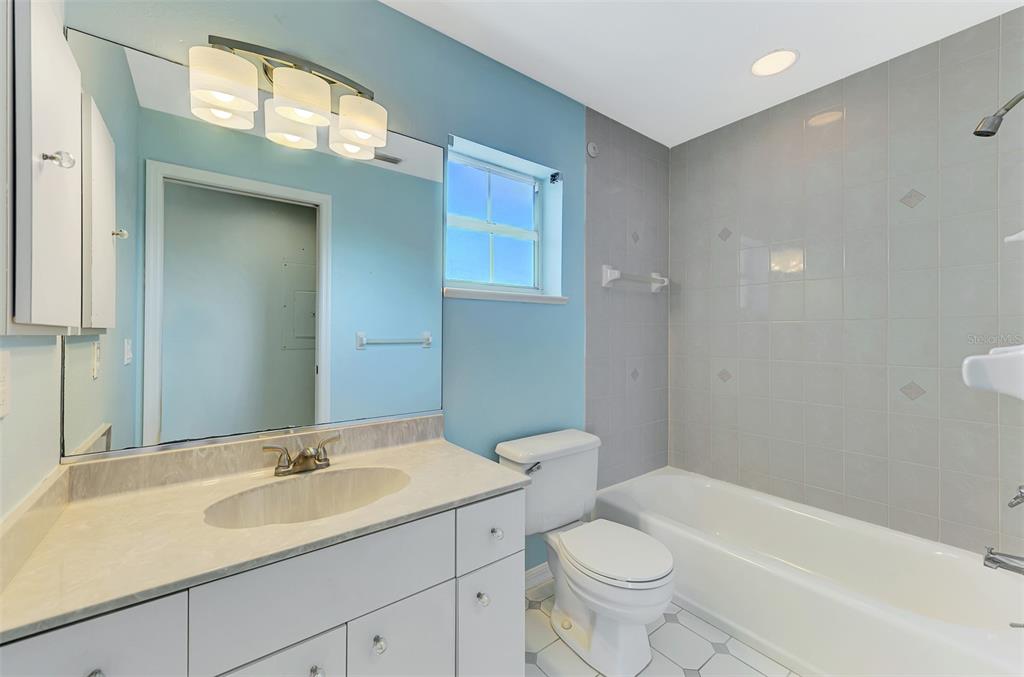 1380 Beach Road, Unit 4 Englewood, FL 34223 - Photo 34 of 47 a bathroom with a sink a toilet and shower