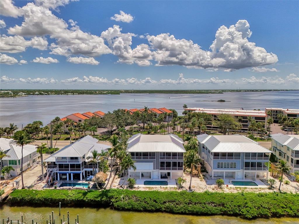 1380 Beach Road, Unit 4 Englewood, FL 34223 - Photo 44 of 47 a view of a city with lawn chairs under an umbrella