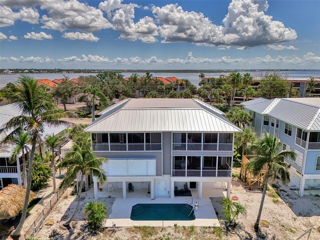 1380 Beach Road, Unit 4 Englewood, FL 34223 - Photo 45 of 47 a front view of a house with a yard and potted plants