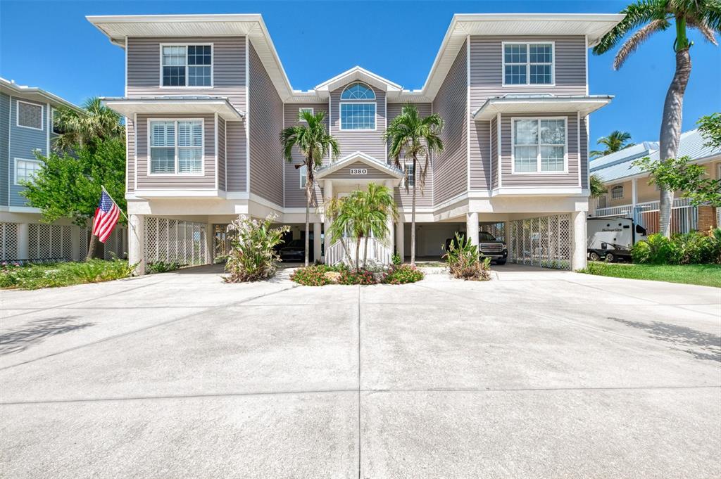 1380 Beach Road, Unit 4 Englewood, FL 34223 - Photo 9 of 47 a front view of a building with a garden
