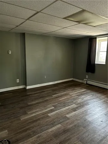 a view of a room with wooden floor and a window