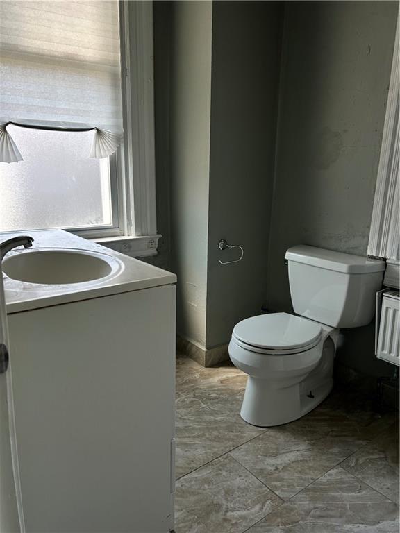 231 Ulysses Street, Unit 1 Pittsburgh, PA 15211 - Photo 9 of 13 a bathroom with a granite countertop toilet and a sink