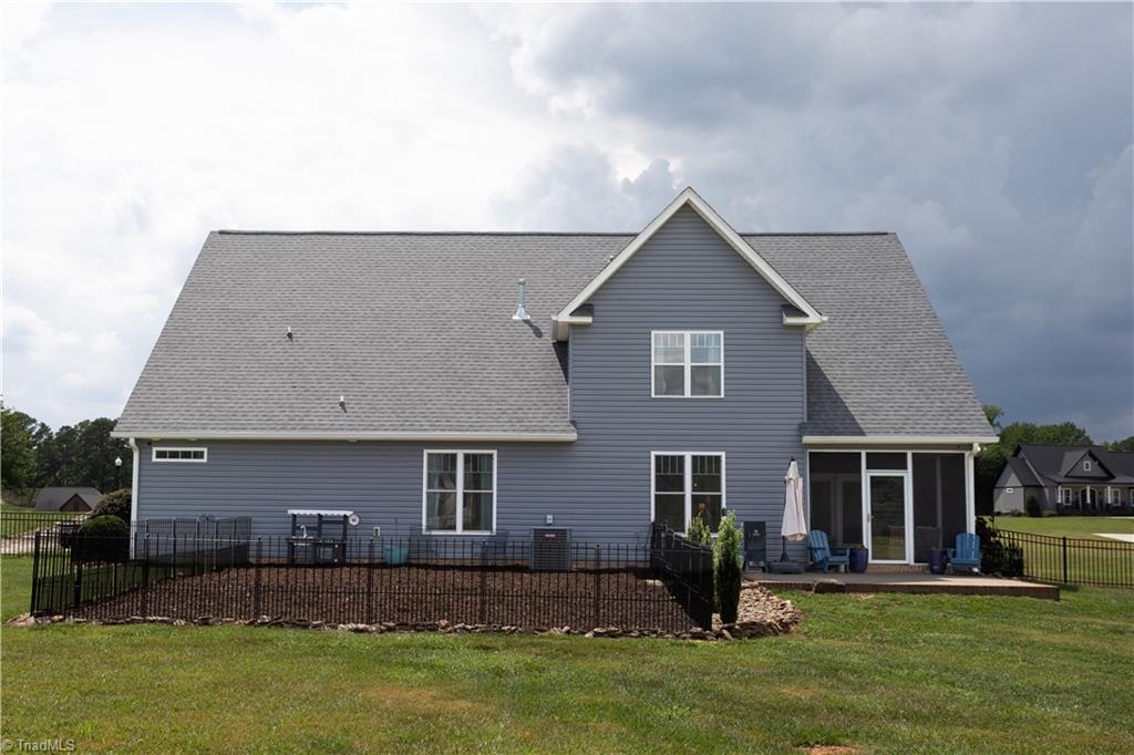 393 Scout Road Lexington, NC 27292 - Photo 45 of 47 View from the huge backyard toward the back of the home. Note that the small fenced area is a small space the current owners installed for a smaller play yard inside of the larger fenced area.