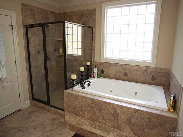 9108 Wellsley Way Raleigh, NC 27613 - Photo 7 of 14 Whirlpool tub - sep shower - custom tile - granite countertops - dual vanity with custom cabinets and seperate water closet - accesses very spacious Walk In Closet Master Bath/Spa