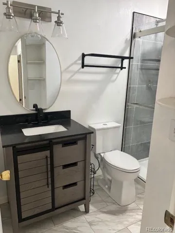 a bathroom with a sink toilet and mirror