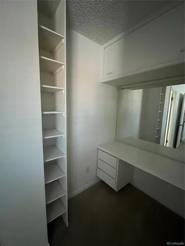 a living room with walk in closet and window