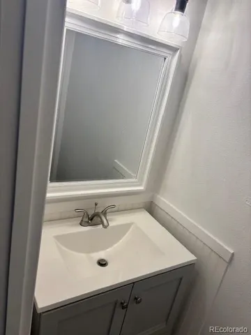 a bathroom with a sink a mirror and vanity