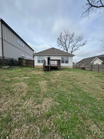 a view of a house with a yard and sitting area
