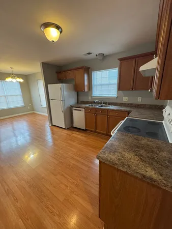 a kitchen with stainless steel appliances granite countertop a sink and a stove