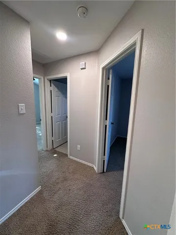 an empty room with closet and mirror