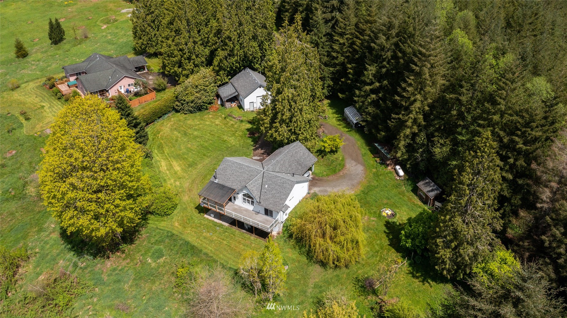 a aerial view of a house with a yard swimming pool and outdoor seating