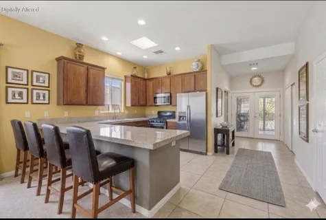 a large kitchen with cabinets table and chairs