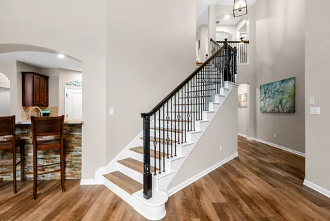 a view of entryway and hall with wooden floor