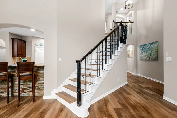 a view of entryway and hall with wooden floor