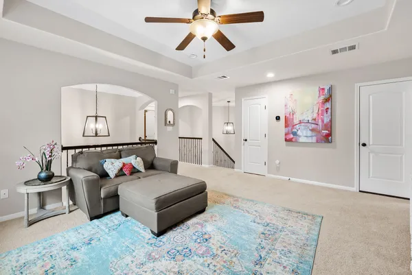 a living room with furniture and a chandelier