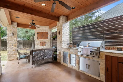 a kitchen with stove and chairs