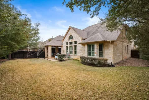 a view of a house with a yard and sitting area