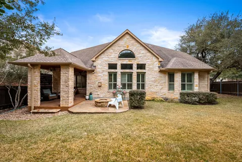 a front view of a house with a yard and seating space