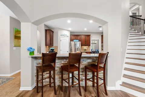 a view of a dining room with furniture and a window