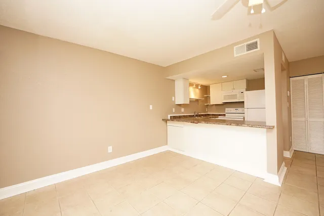 a view of kitchen with refrigerator sink