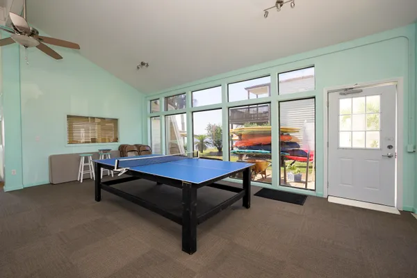 a living room with furniture a ceiling fan and a window