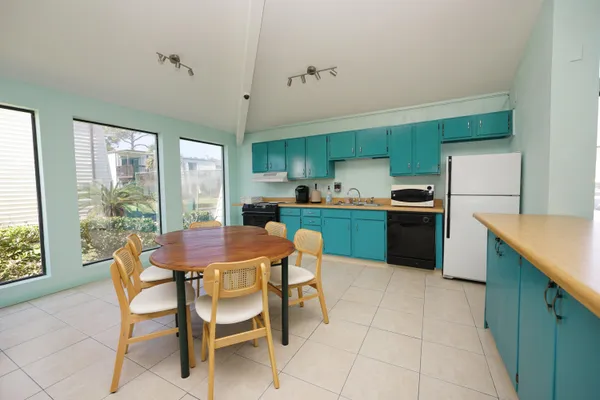 a kitchen with a table and chairs in it