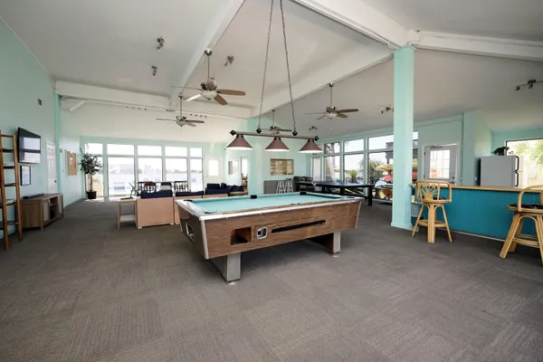 a room with pool table and furniture