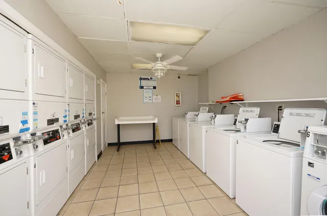 a utility room with cabinets dryer and washer