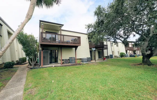 a view of a house with a yard and sitting area