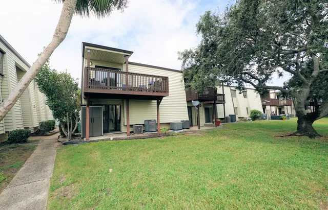 a view of a house with a yard and sitting area