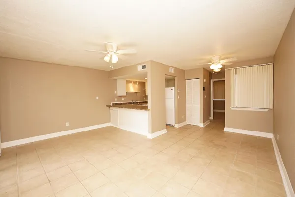 a view of kitchen with refrigerator and window