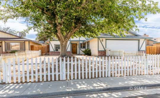 613 South Silver Ridge Street Ridgecrest, CA 93555 - Photo 3 of 26 a front view of white house with a small garden