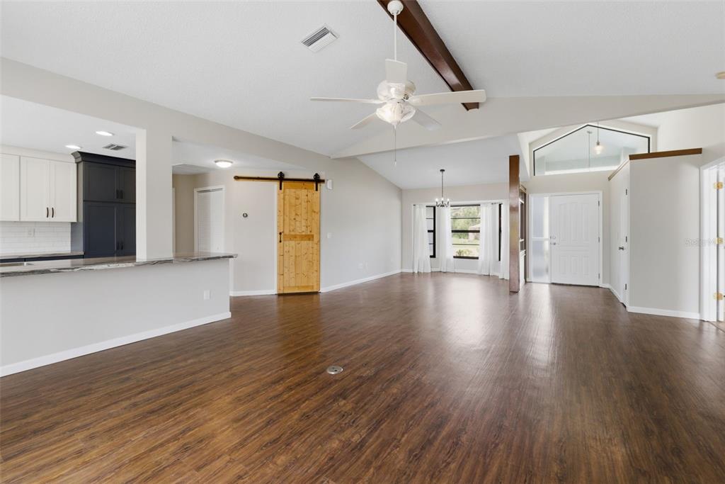 4966 Keysville Avenue Spring Hill, FL 34608 - Photo 15 of 48 wooden floor in an empty room with a kitchen