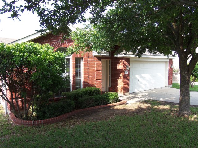 1210 Springbrook Road Pflugerville, TX 78660 - Photo 1 of 1 a front view of a house with garden
