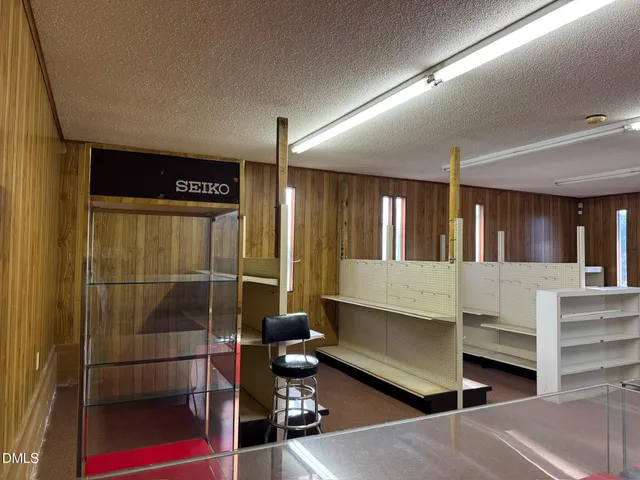 a living room with lots of furniture and a large window