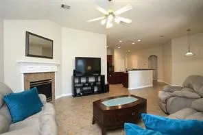 a living room with furniture a fireplace and a flat screen tv