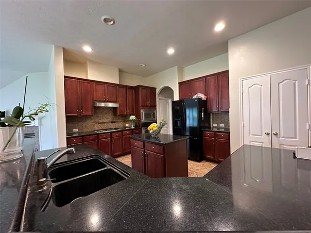 a kitchen with stainless steel appliances a refrigerator and a stove