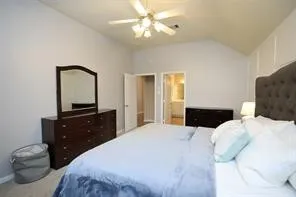 a bedroom with a bed and a dresser