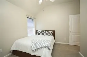 a bedroom with a bed and a window
