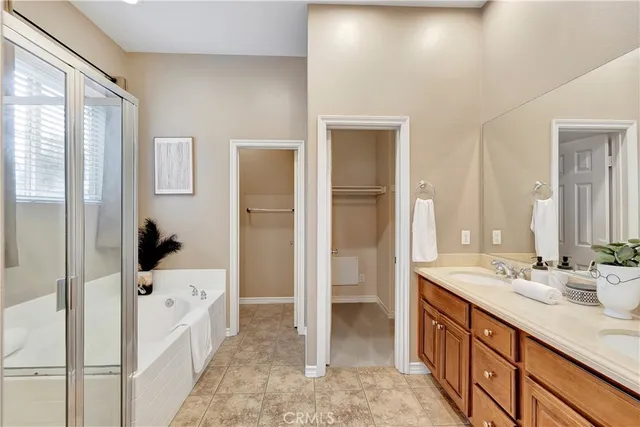 a spacious bathroom with a bathtub sink and mirror