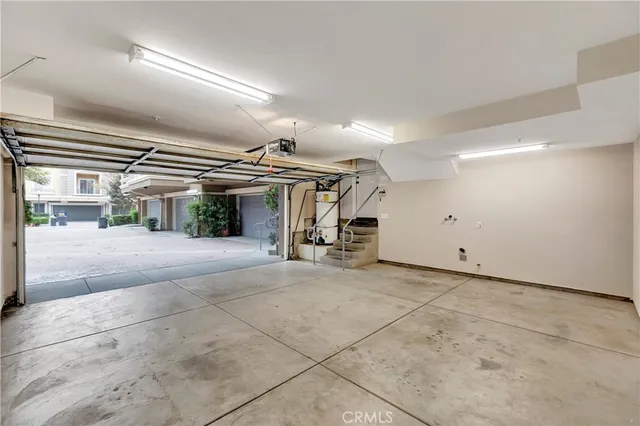 a view of a patio with a table and chairs under an umbrella