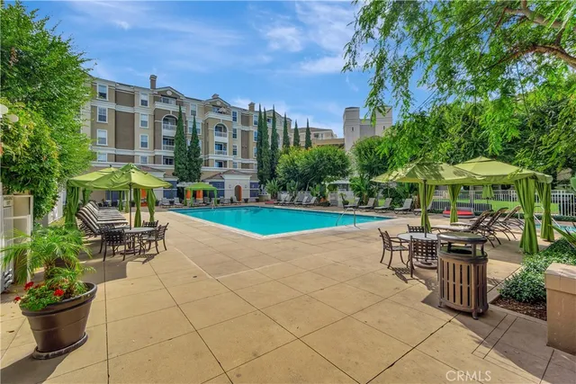 a view of a patio with a table and chairs under an umbrella