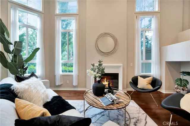 a living room with furniture fireplace and window