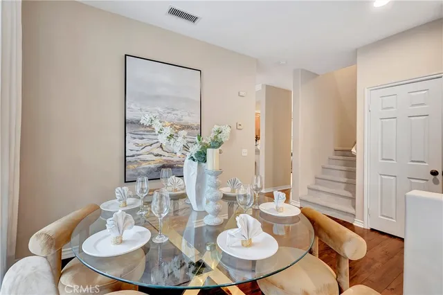a dining room with furniture and wooden floor