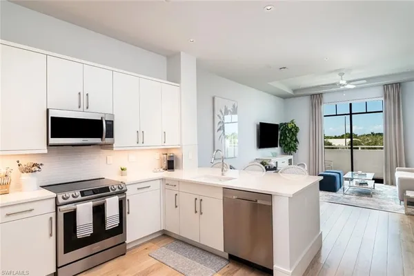 a kitchen with a sink stove and microwave