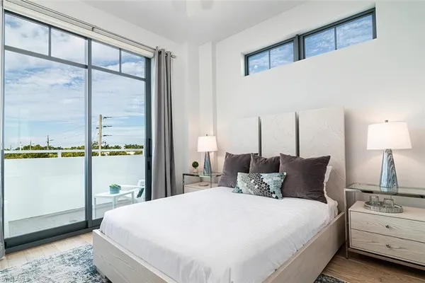 a bedroom with a large bed and a large window