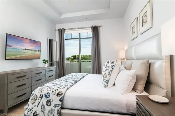 a bedroom with a bed and a flat screen tv