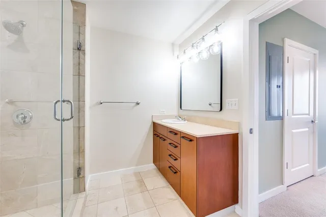 a bathroom with a double vanity sink mirror and shower