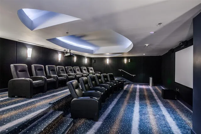 a media room with lots of chairs and a rug