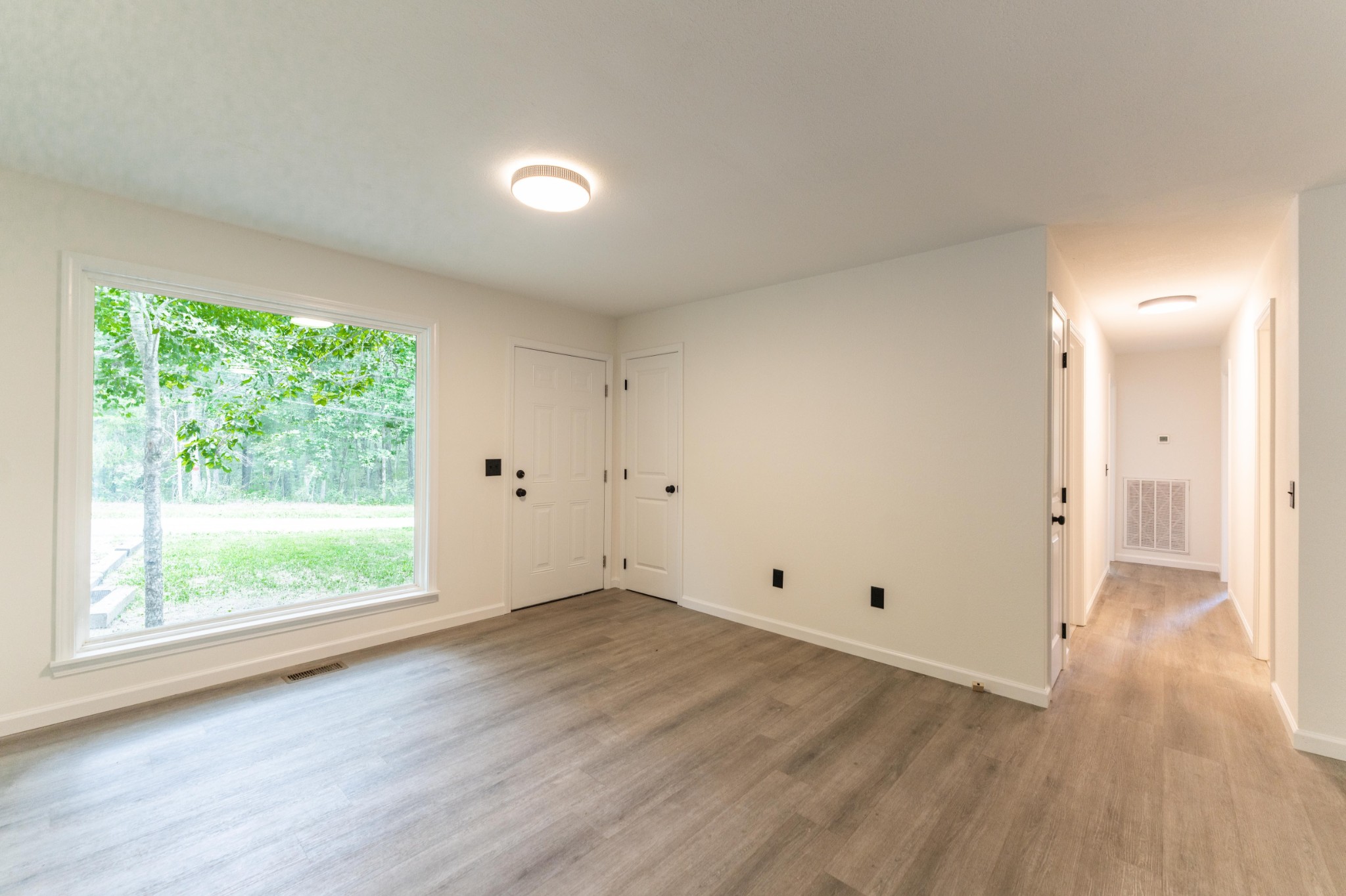 316 Kerrigan Road Crossville, TN 38555 - Photo 3 of 19 a view of an empty room with wooden floor and a window